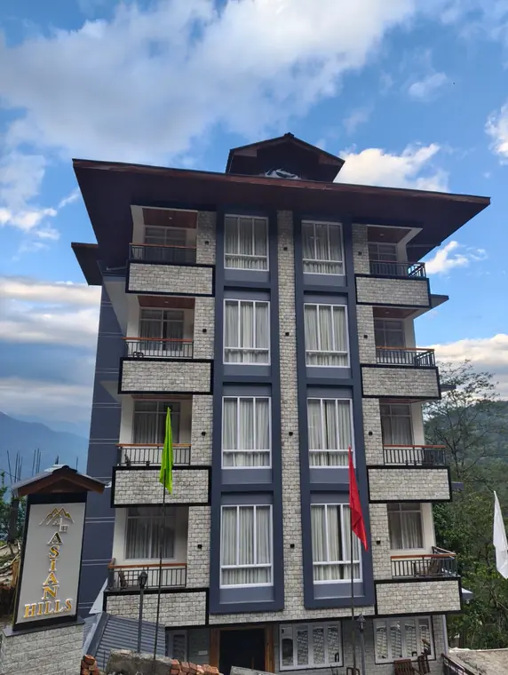 The hotel building photographed from the road on a bright day