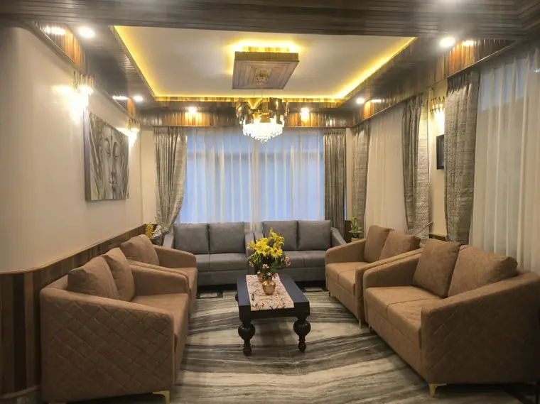 Lounge seating with beige sofas and a decorative ceiling