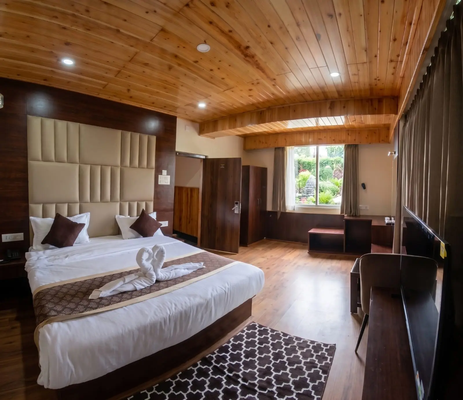Premium room interior with pine ceiling and mountain-facing windows