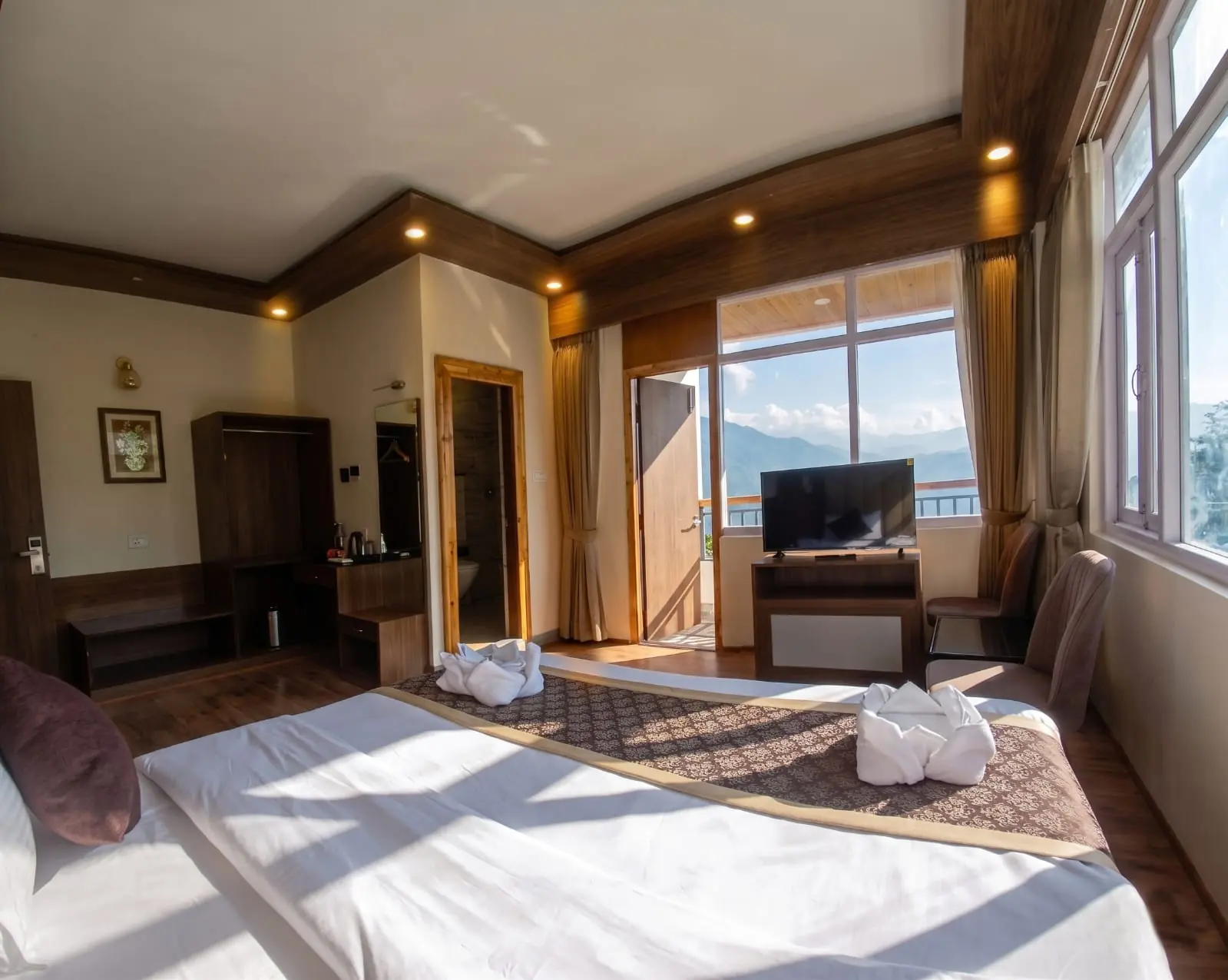 Morning light entering a guest room through the open balcony doors